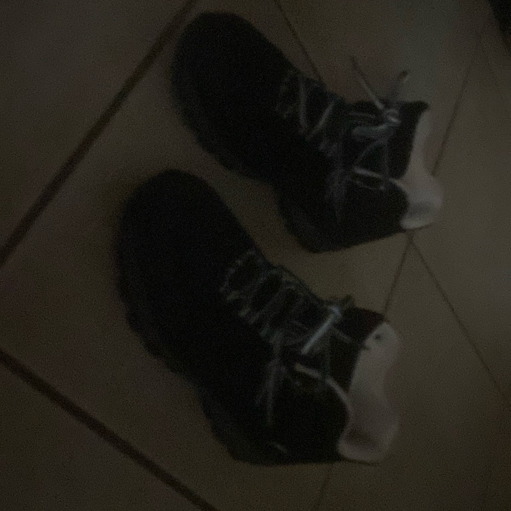 Black hiking boots with white and black shoe laces.